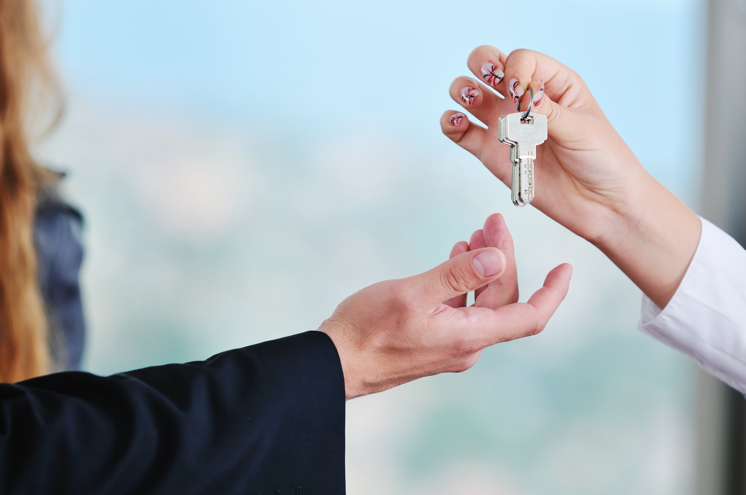 A woman handing keys over